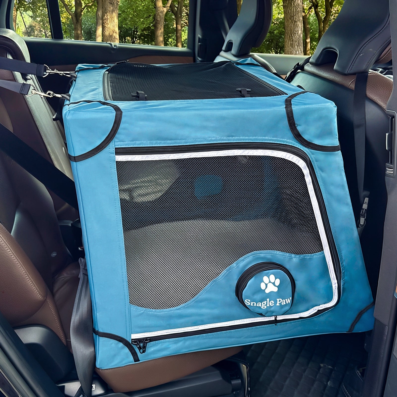 Close-up of the Snagle Paw dog crate featuring four-fold safety with adjustable headrest straps and seatbelt loops.