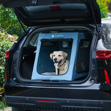 Rear view of a black SUV with a Snagle Paw travel dog crate installed, featuring a happy Labrador inside.