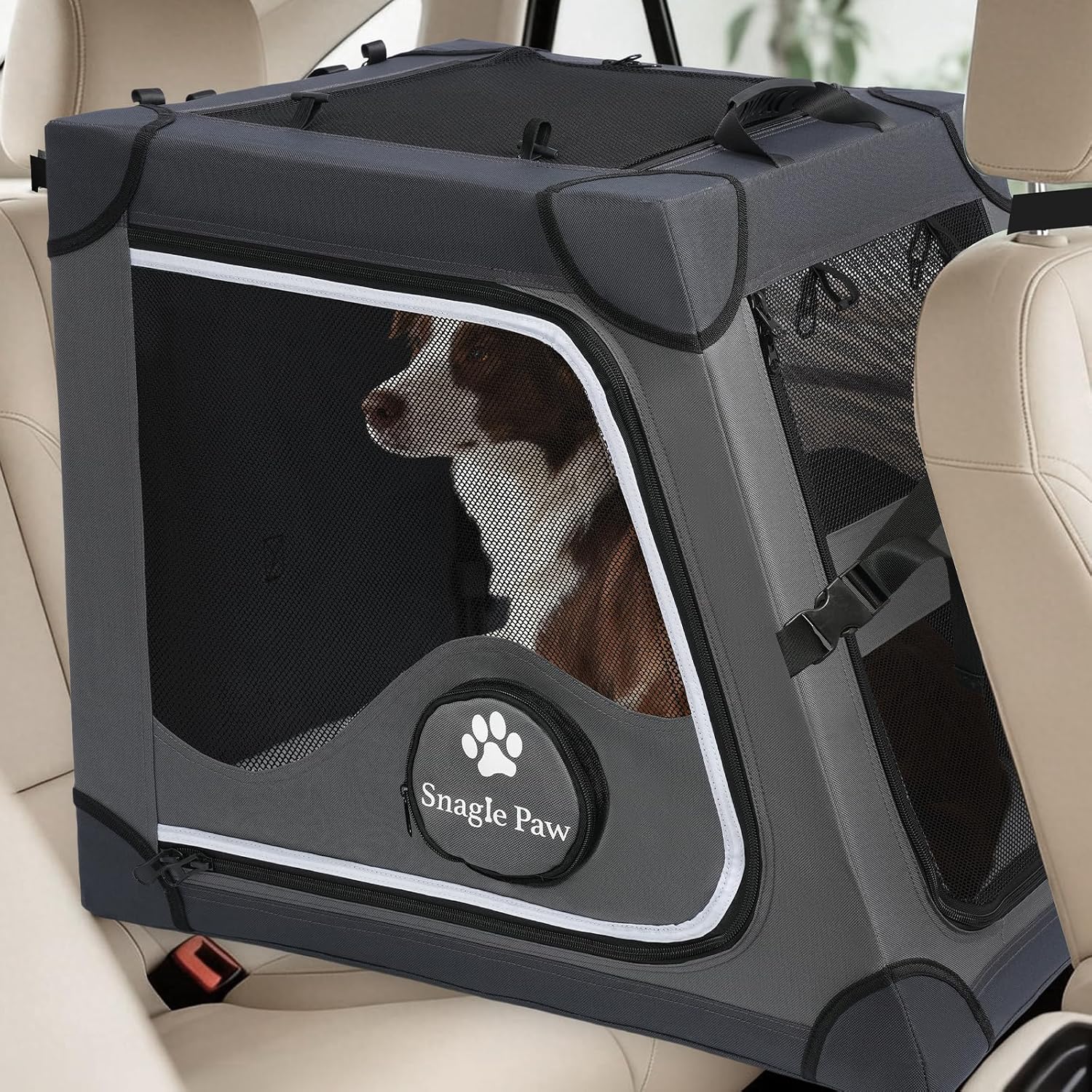 A German Shepherd looking out from a grey Snagle Paw Travel Dog Crate for Car Back Seat installed on the rear car seat.