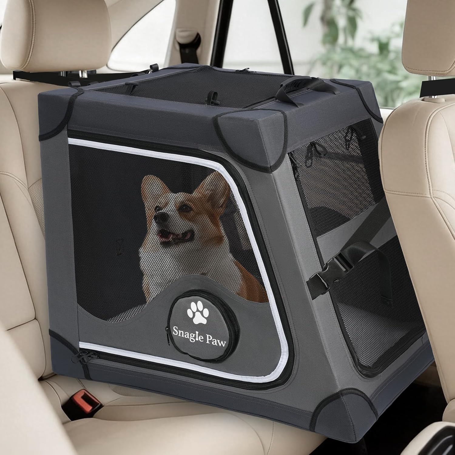 A Corgi sitting inside a grey Snagle Paw Travel Dog Crate for Car Back Seat secured in a vehicle.